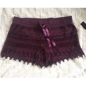 Netted style shorts with satin waist belt.